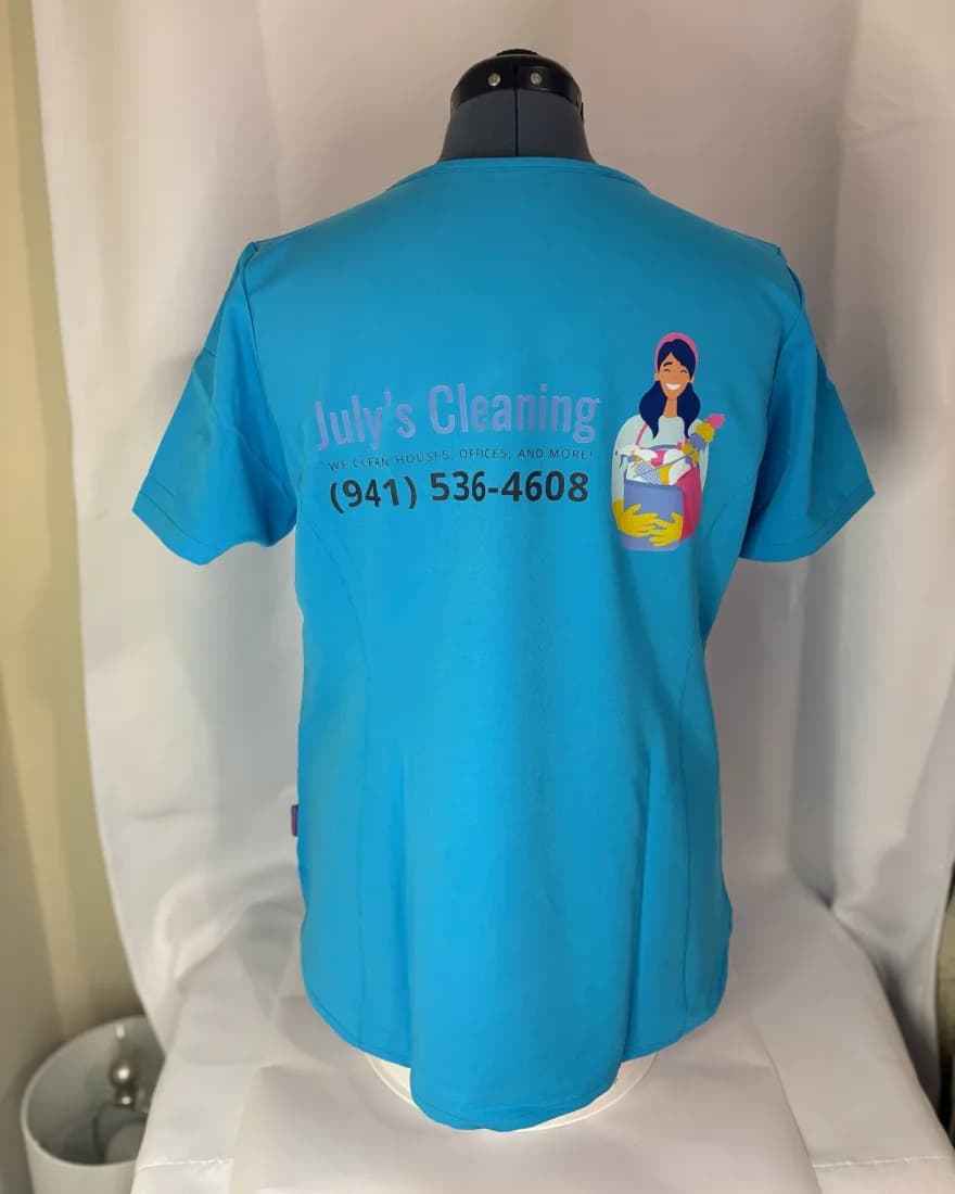 Turquoise tee printed with the July's Cleaning logo and phone number